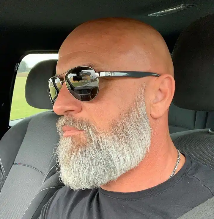 17 Bold Beard Styles for Bald Men to Stand Out 11 Wavy Silver Beard That Blends Into the Sideburns