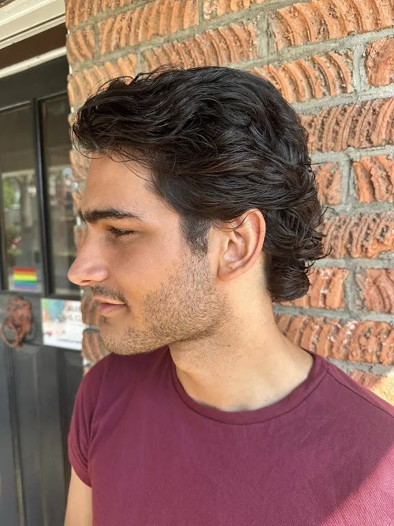 20 Wavy Hair Men Ideas That Look Natural and Stylish Now 7 The Brushed Back Wave with Glossy Finish