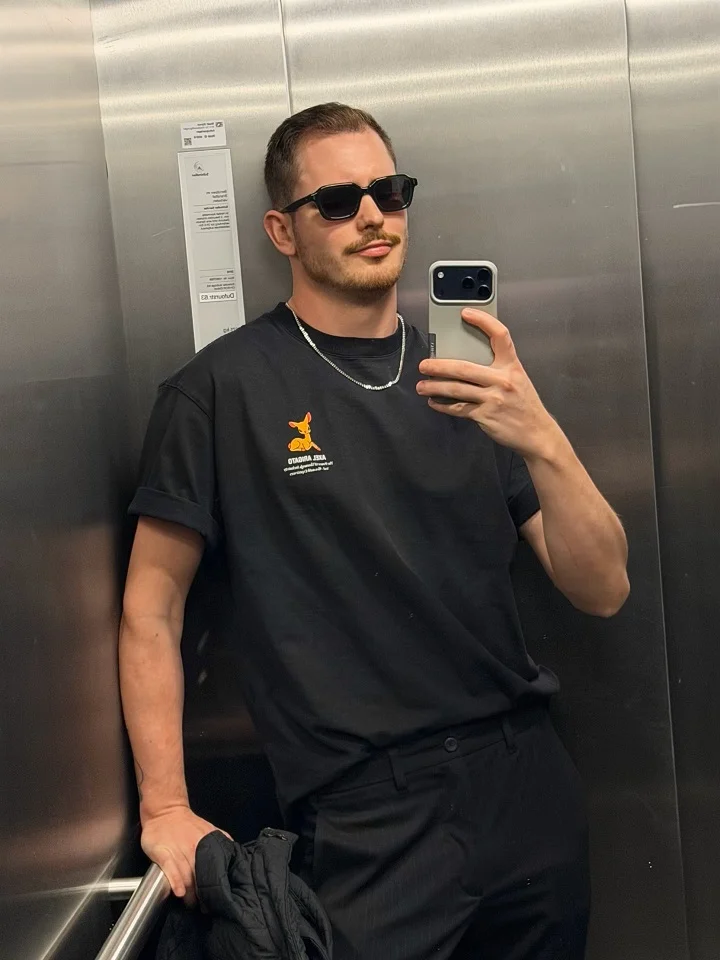 21 Stylish Black Outfit Ideas for Men That Look Effortlessly Cool 8 A Small Graphic Black Tee With Clean Trousers