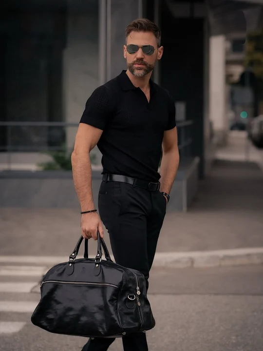21 Stylish Black Outfit Ideas for Men That Look Effortlessly Cool 6 Textured Black Knit Polo With a Leather Weekender