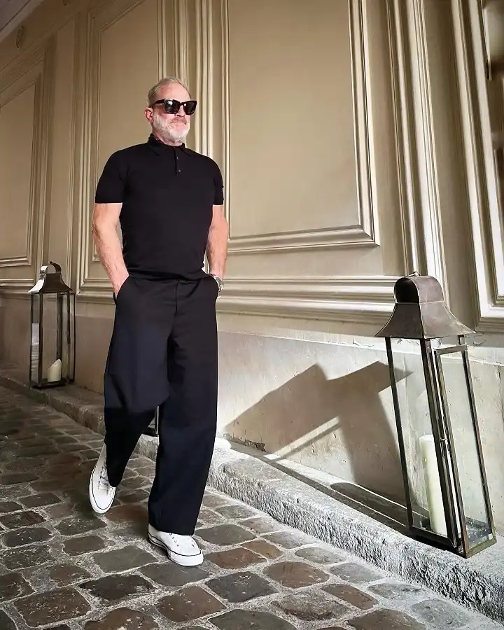 16 Wide Pants Outfit Ideas for Men That Actually Look Put Together 12 All Black Wide Trousers and a Polo for Effortless European Ease