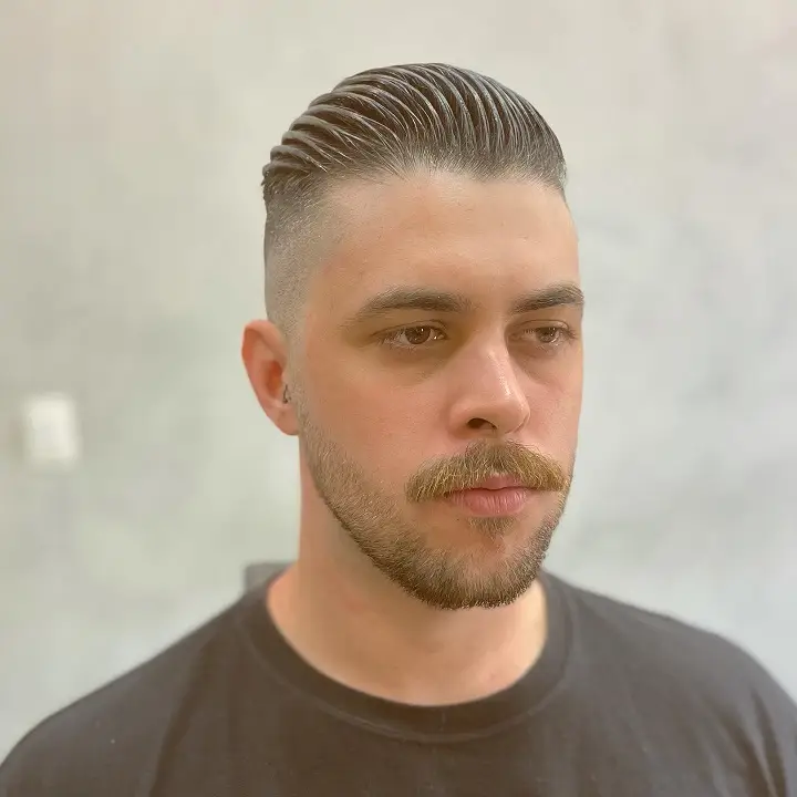 The Comb Track Slick Back with a Side Part and Skin Fade