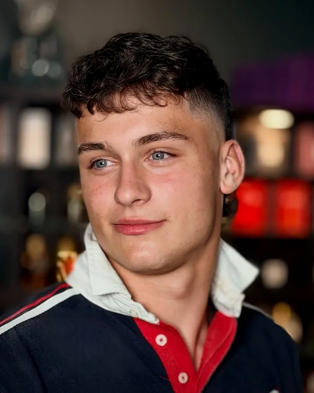 15 Hair Designs for Men (And Exactly What to Ask Your Barber For) 3 Curly Fringe With A Clean Side Fade