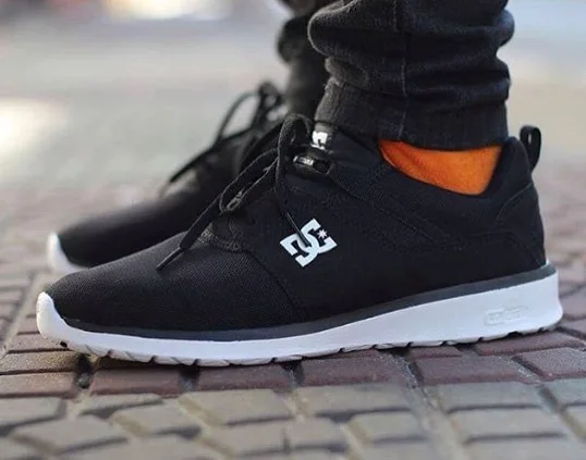 Black Runners With Slim Jeans and Orange Socks
