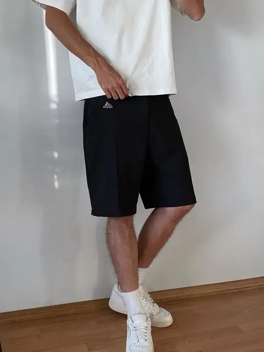 22 Black Shorts Outfit Ideas for Men That Actually Look Put Together 21 White Tee and Pleated Black Shorts, Fit Details Up Close