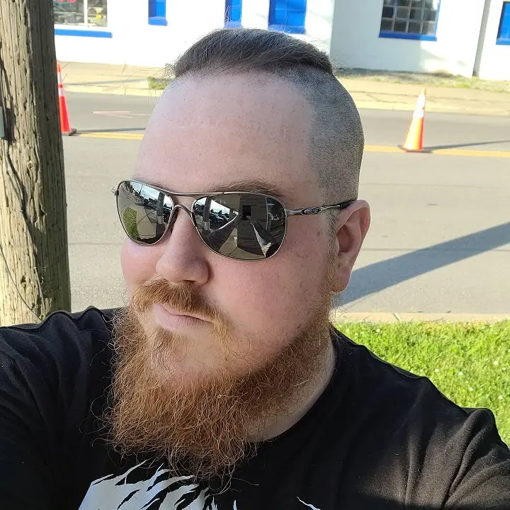 22 Warrior Haircut Ideas for Men: Braids, Fades, and Full Beards 17 Cropped Silver Top With a Long Copper Beard