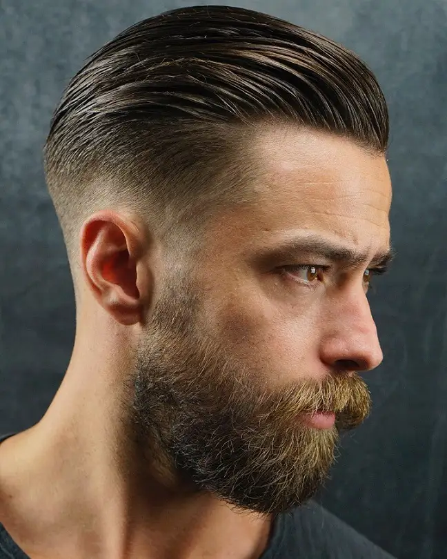20 Pompadour Hairstyles for Men, From Skin Fades to Soft Tapers 13 Slicked Back Pompadour With a Full Beard