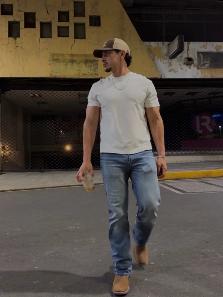 Light Wash Straight Jeans With Tan Boots and a Trucker Cap