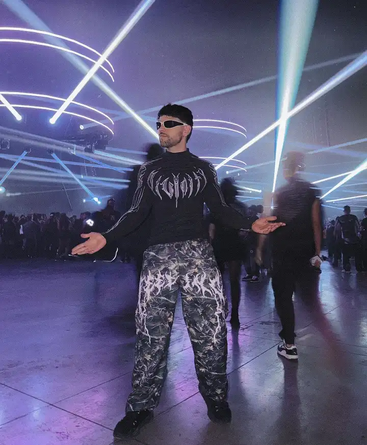 25 Rave Outfits for Men That Go All-in on Style 2 Gothic Lettering Top Paired With Camo Cargo Pants for Instant Edge