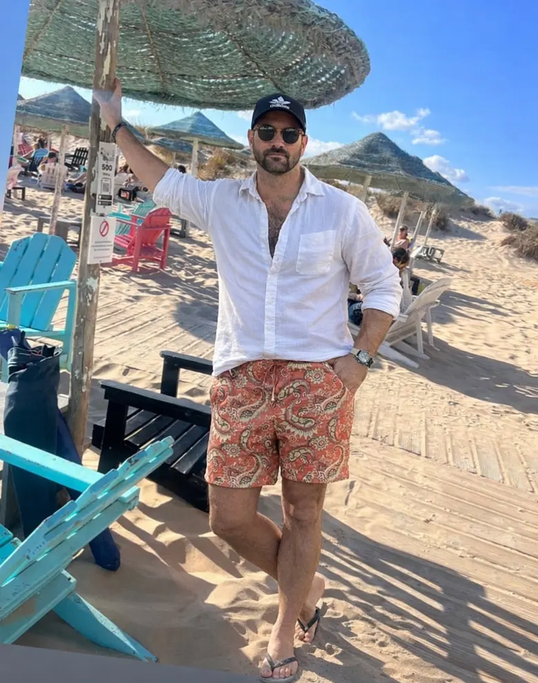 Paisley Swim Shorts Under an Open White Linen Shirt