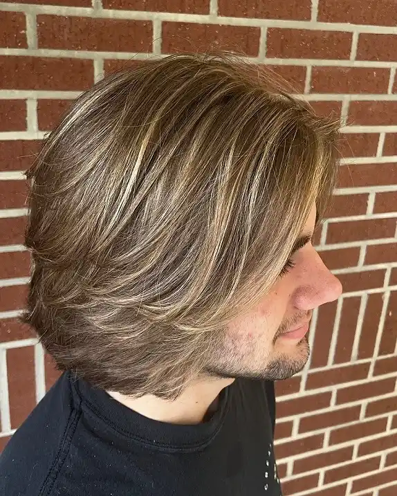 15 Cool Blonde Hair Ideas for Men That Look Fresh, Not Bleached 14 Layered Bronde Shag With Face-Framing Pieces