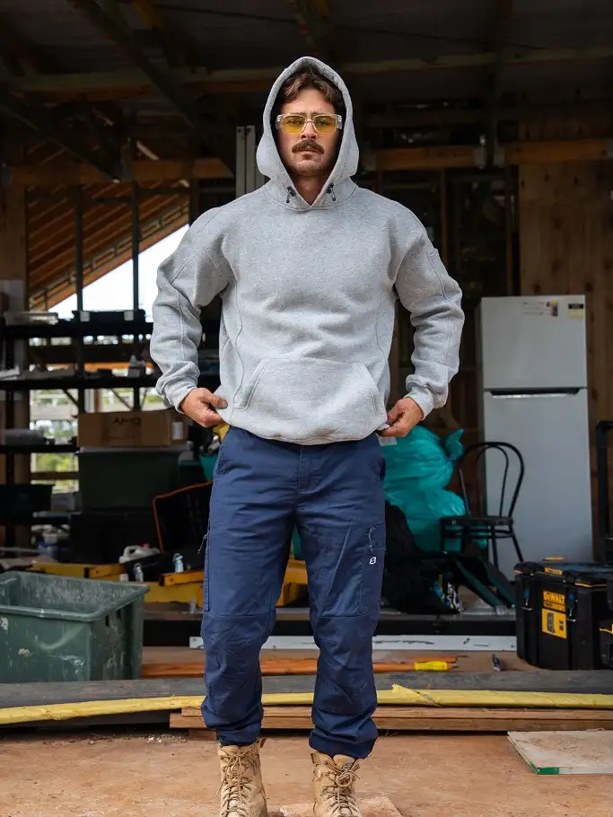 21 Winter Work Outfit Ideas for Men, From Wool Suits to Jobsite Layers 11 Heavy Grey Hoodie and Navy Cargo Trousers
