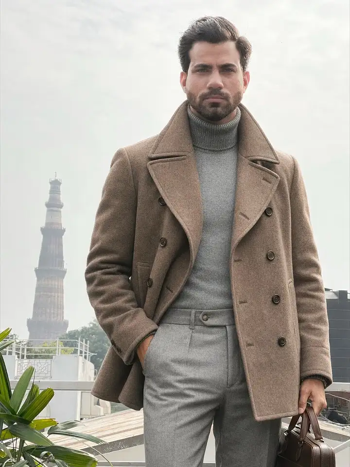 21 Winter Work Outfit Ideas for Men, From Wool Suits to Jobsite Layers 7 Taupe Peacoat Over a Grey Turtleneck