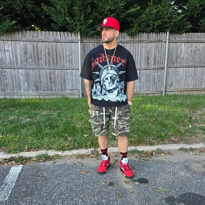 Woodland Camo Shorts With Red Jordans and a Fitted Cap