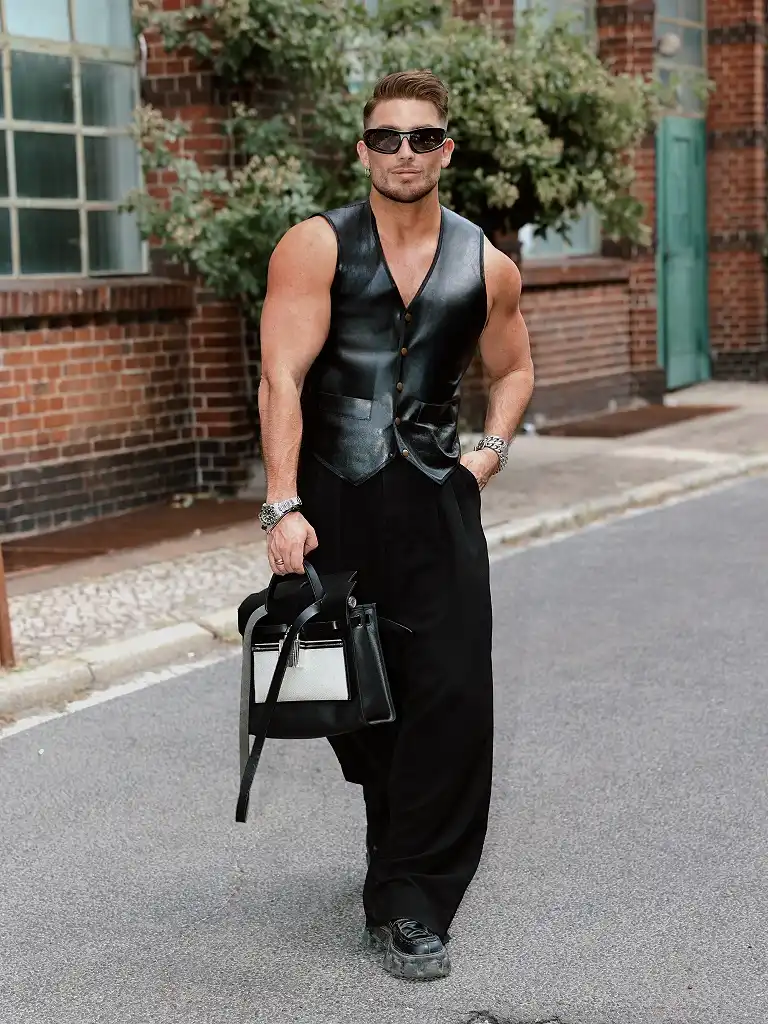 25 Rave Outfits for Men That Go All-in on Style 14 Leather Vest and Wide Black Trousers for a Sleek Rave Night Look