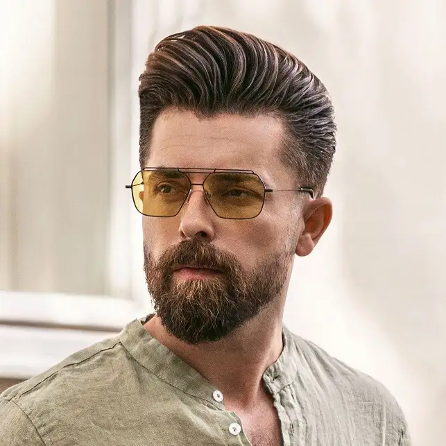 20 Pompadour Hairstyles for Men, From Skin Fades to Soft Tapers 3 Side Swept Pompadour With a Full Beard