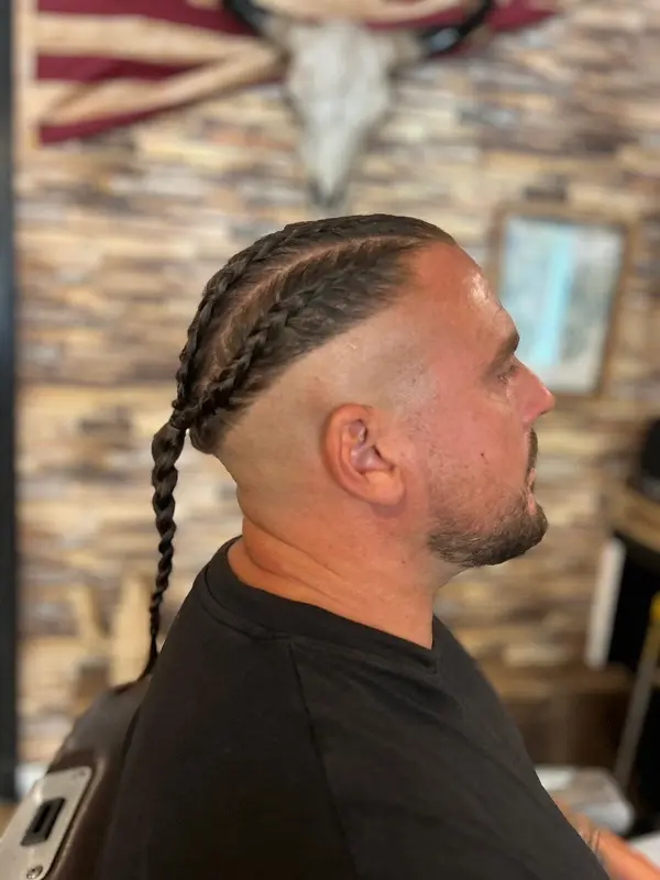 22 Warrior Haircut Ideas for Men: Braids, Fades, and Full Beards 14 Twin Cornrows Into a Single Braid
