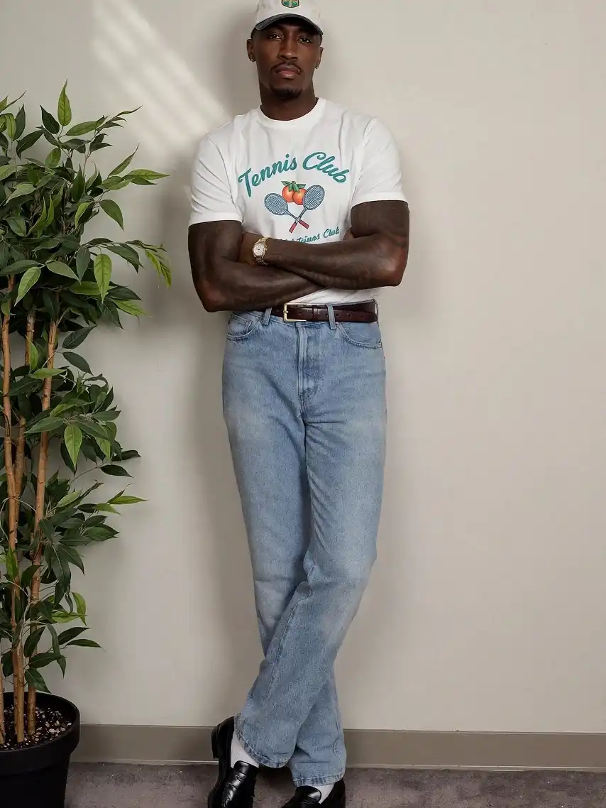 A Graphic Tee Tucked Into Light Wash Denim