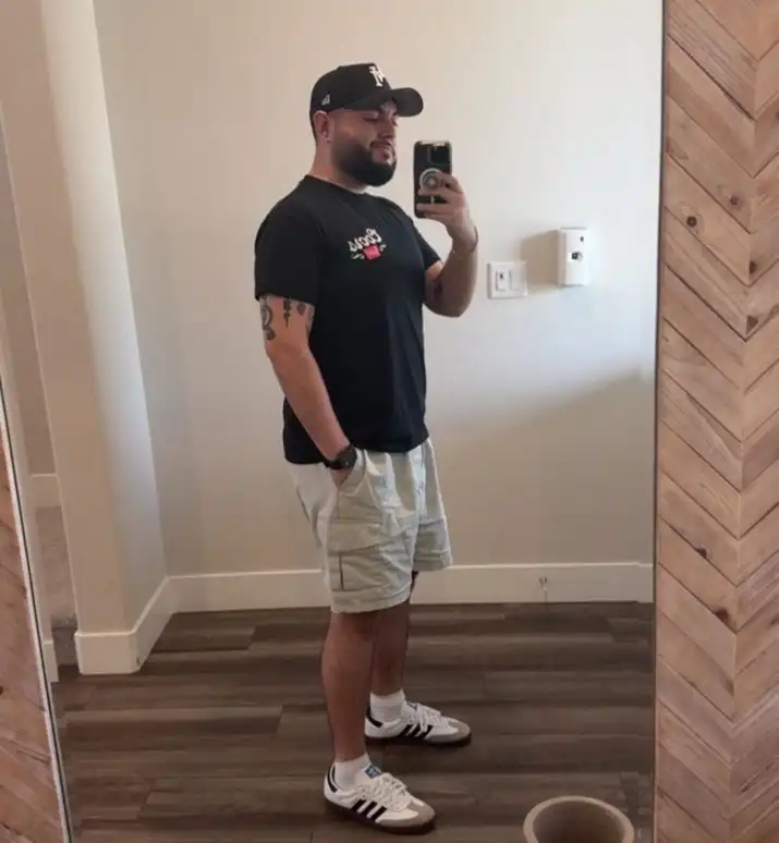 17 Summer Outfits for Short Men Who Want Better Proportions 11 Black Tee With Sage Cargo Shorts
