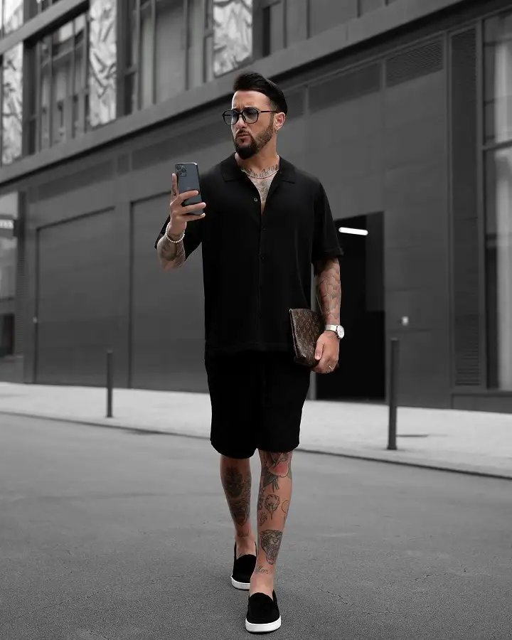 22 Black Shorts Outfit Ideas for Men That Actually Look Put Together 18 Boxy Black Shirt, Black Shorts, and One Brown Accessory