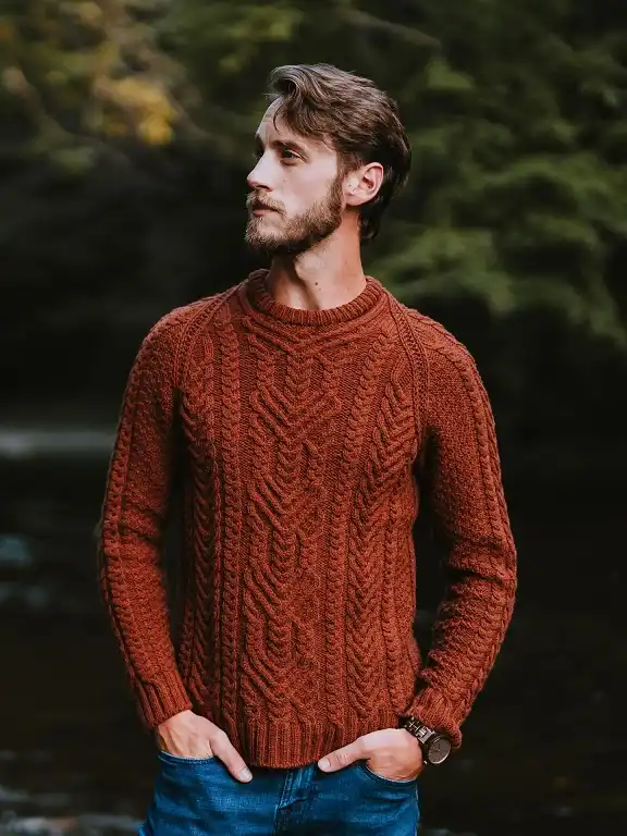 20 Cable Knit Sweater Outfits For Men That Look Expensive 20 Rust Aran Knit With Mid Blue Jeans By The Water