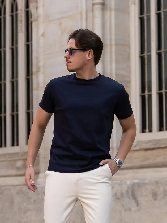 21 Men's T-Shirt Outfit Ideas That Actually Look Put Together 15 Navy Tee Tucked Into Cream Trousers