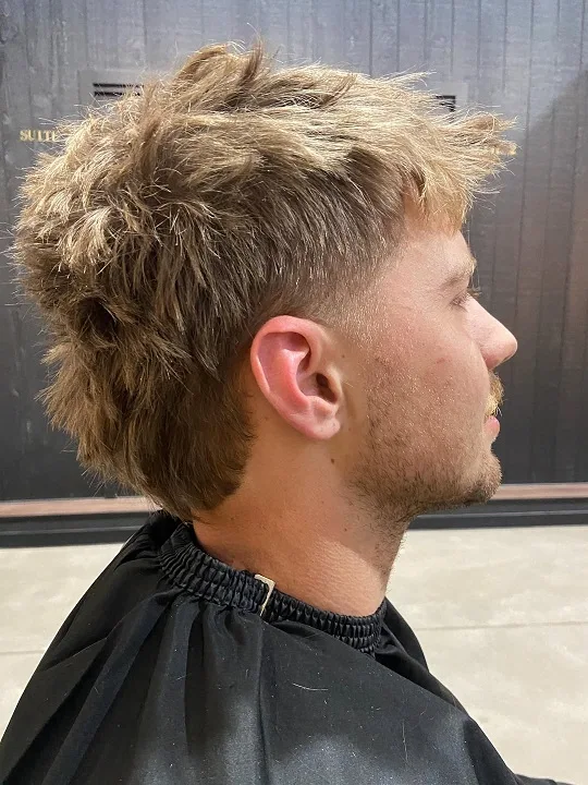 22 Warrior Haircut Ideas for Men: Braids, Fades, and Full Beards 11 Blond Shag Mullet With Choppy Layers