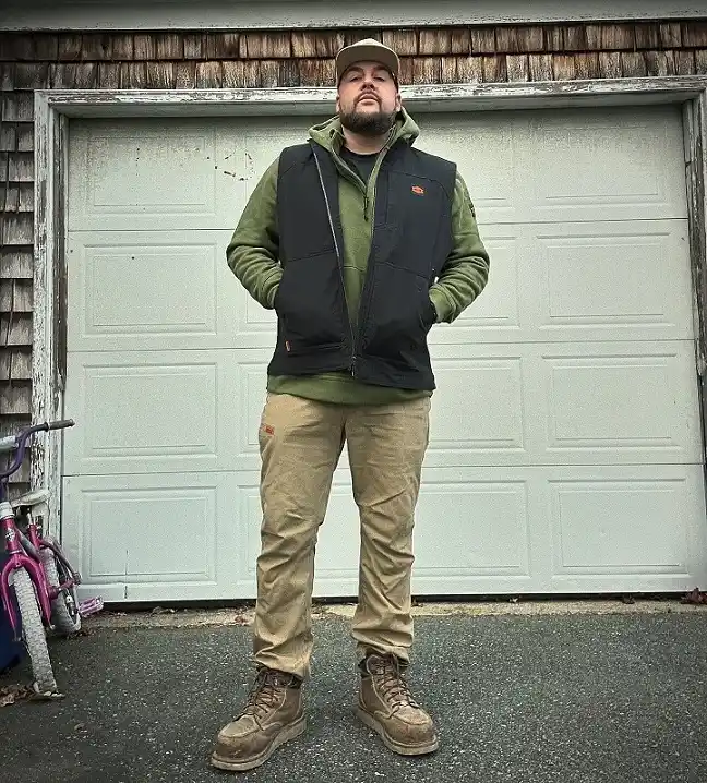 21 Winter Work Outfit Ideas for Men, From Wool Suits to Jobsite Layers 10 Work Vest Over a Green Fleece Hoodie