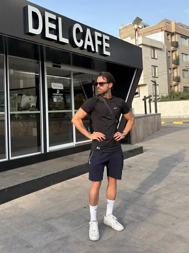 Black Tee With Navy Shorts and a Crossbody Strap