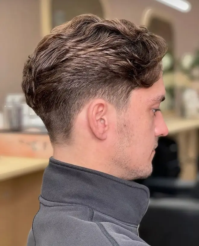 23 Sharp Gentleman Haircuts That Never Go Out of Style 14 Wavy Textured Top With a Low Taper
