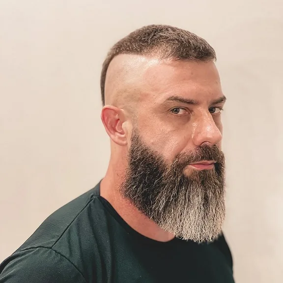 22 Warrior Haircut Ideas for Men: Braids, Fades, and Full Beards 7 High Skin Fade With a Long Full Beard