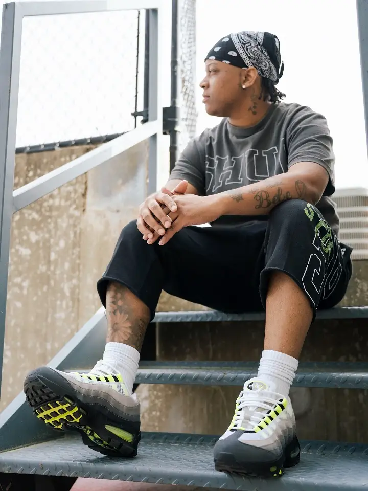 22 Black Shorts Outfit Ideas for Men That Actually Look Put Together 20 Washed Graphic Tee With Neon Trimmed Sneakers