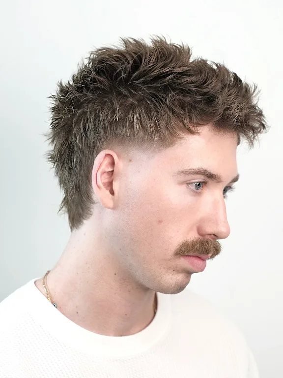 22 Warrior Haircut Ideas for Men: Braids, Fades, and Full Beards 3 Textured Mullet With a Low Taper