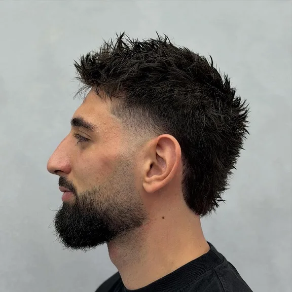 22 Warrior Haircut Ideas for Men: Braids, Fades, and Full Beards 10 Spiky Dark Crop With a Mid Fade