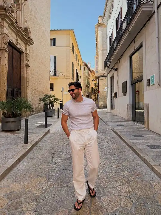 17 Minimalist Summer Outfits for Guys: Cool, Clean, Effortless Looks 4 Pleated Trousers and Flip Flops for a Dressed-Down Vacation Look