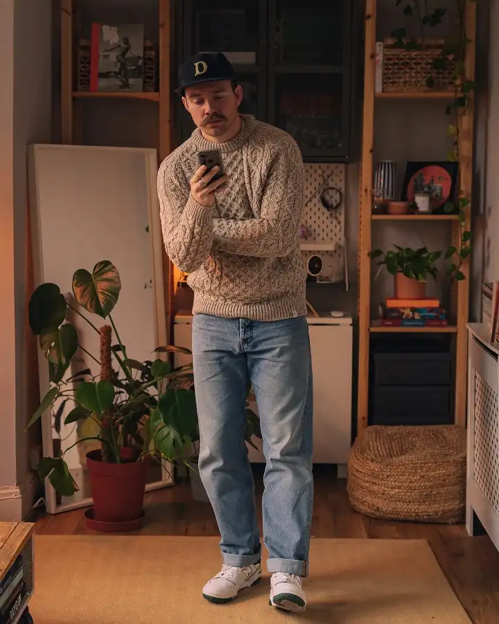 20 Cable Knit Sweater Outfits For Men That Look Expensive 16 Oatmeal Fisherman Knit With Cuffed Light Denim And Sneakers