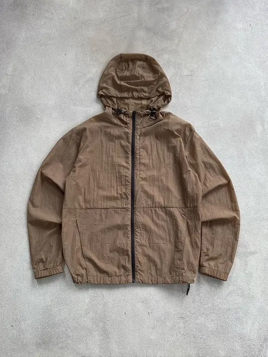 29 Summer Capsule Wardrobe Essentials for Men's Carry-Ons 27 A Featherweight Hooded Jacket in Camel