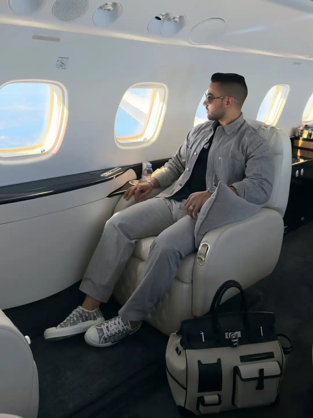 10. Monochromatic Grey Overshirt and Luxury Cabin Duffel