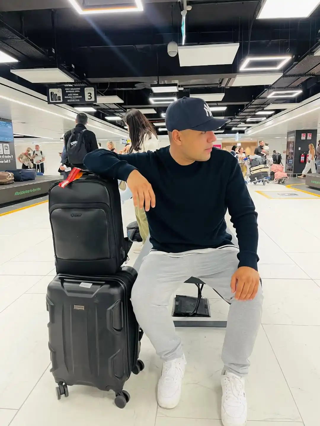 Looking Good at the Gate: 10 Summer Vacation Airport Outfit Ideas for Men 10 9. The Crewneck and Light Grey Joggers Layer