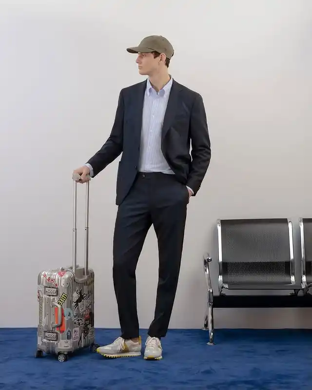 14 Airport Outfit Men With Sneakers Combos to Steal 7 6. Tailored Suit and Baseball Cap Blend