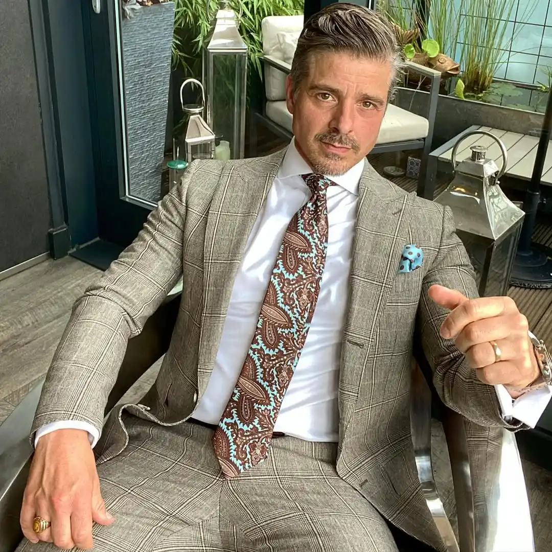 13 Classy Outfits Men Holiday Party Looks for Festive Season 11 10. Glen Plaid Suit with Intricate Paisley Tie