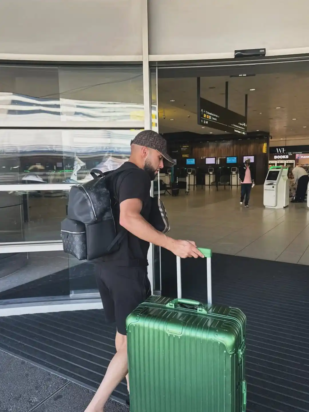 11. Minimalist Black Athletic Set and Metallic Green Suitcase