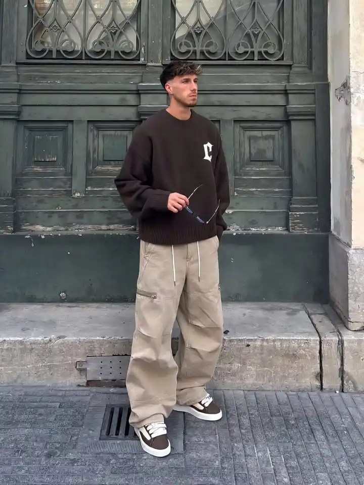 15 Classy Streetwear Outfit Ideas for Men That Elevate the Game 11 9. Graphic Knit Sweater and Baggy Cargos