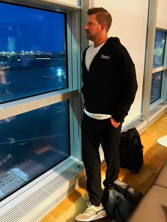10 Airport Outfit Men Over 40 Looks That Feel Age-Appropriate 3 2. The Monochromatic Zip Up Hoodie and Joggers