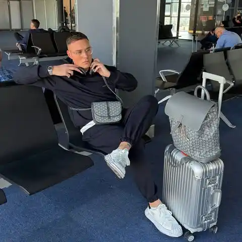 14 Airport Outfit Men With Sneakers Combos to Steal 4 3. Sleek Black Tracksuit with Textured Accessories
