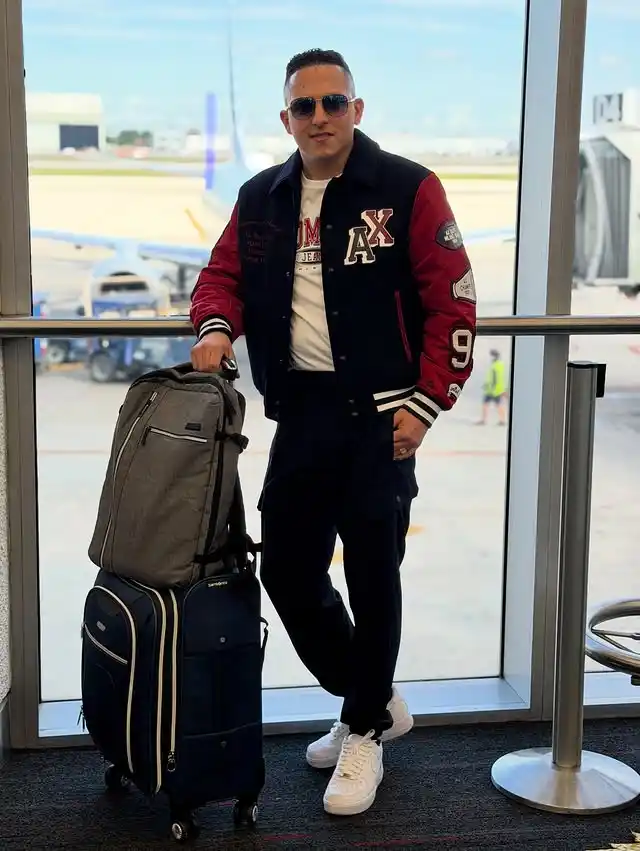 14 Airport Outfit Men With Sneakers Combos to Steal 11 10. Varsity Jacket and Tapered Joggers