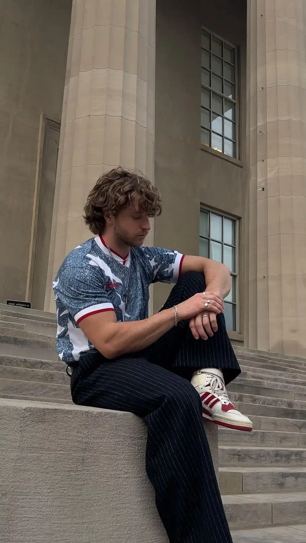 15. Graphic Star Print Jersey With Navy Pinstripe Trousers and Red Adidas Sneakers