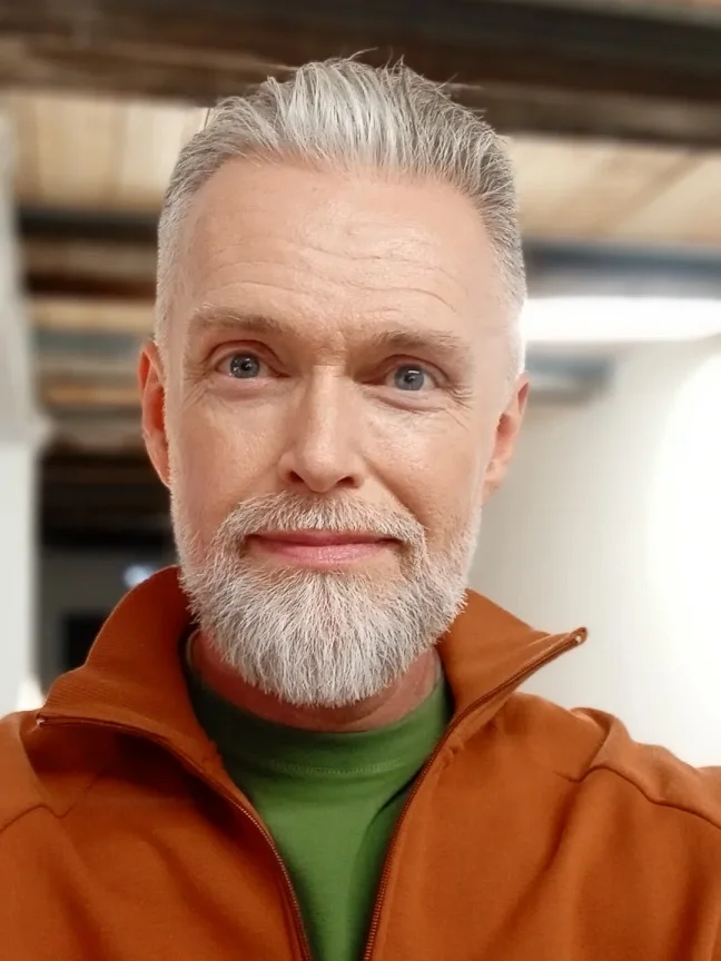 Grey Hair Styles for Men Over 50: 18 Looks That Command Respect 13 A Swept Back Silver Style Paired With Color That Works For It