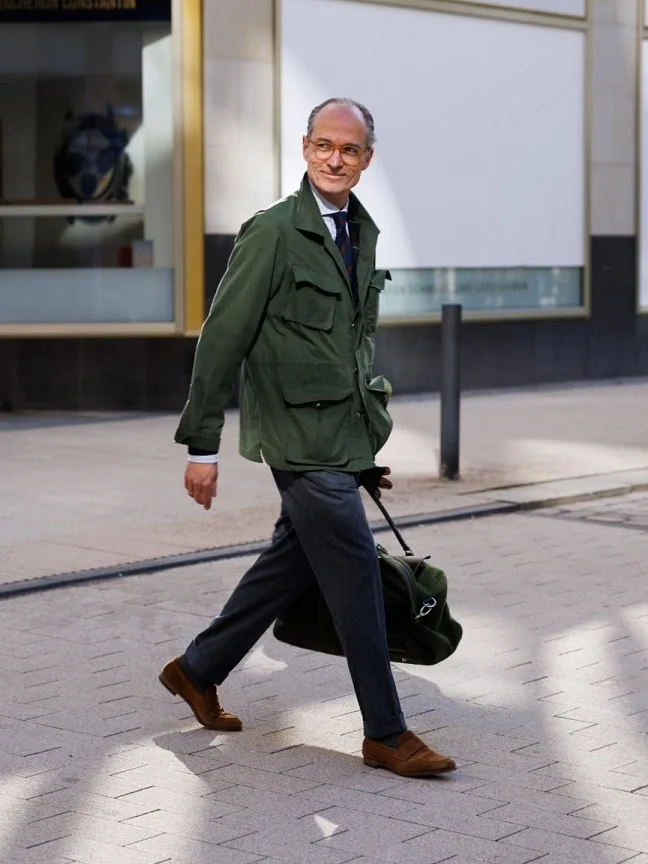 16 Stylish Airport Outfits for Men on Business Trips 17 A Field Jacket Over a Shirt and Tie Proves Utility Style Still Reads Business