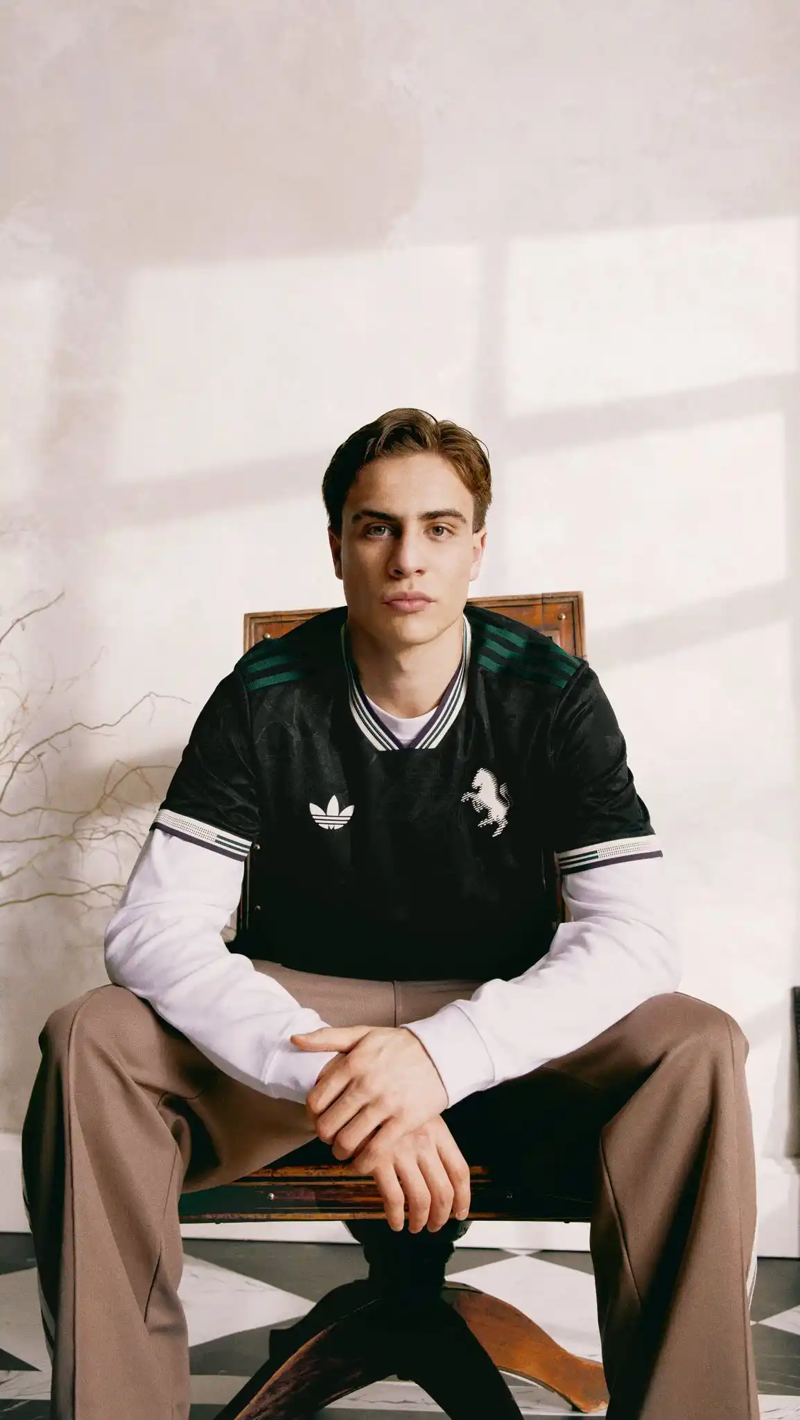 13. Black Adidas Jersey Over White Long Sleeve Shirt With Taupe Trousers